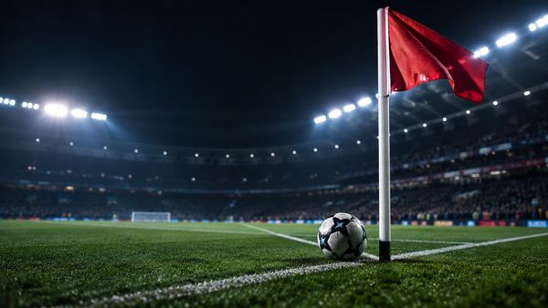 Jalkapallo kulmalipun juurella valaistulla kentällä yöllä, lippu liehuu, stadion sumeana, kulmapotkut